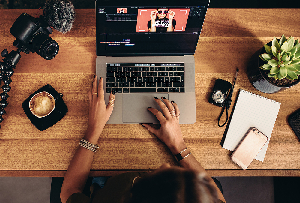 person in front of a laptop watching a video