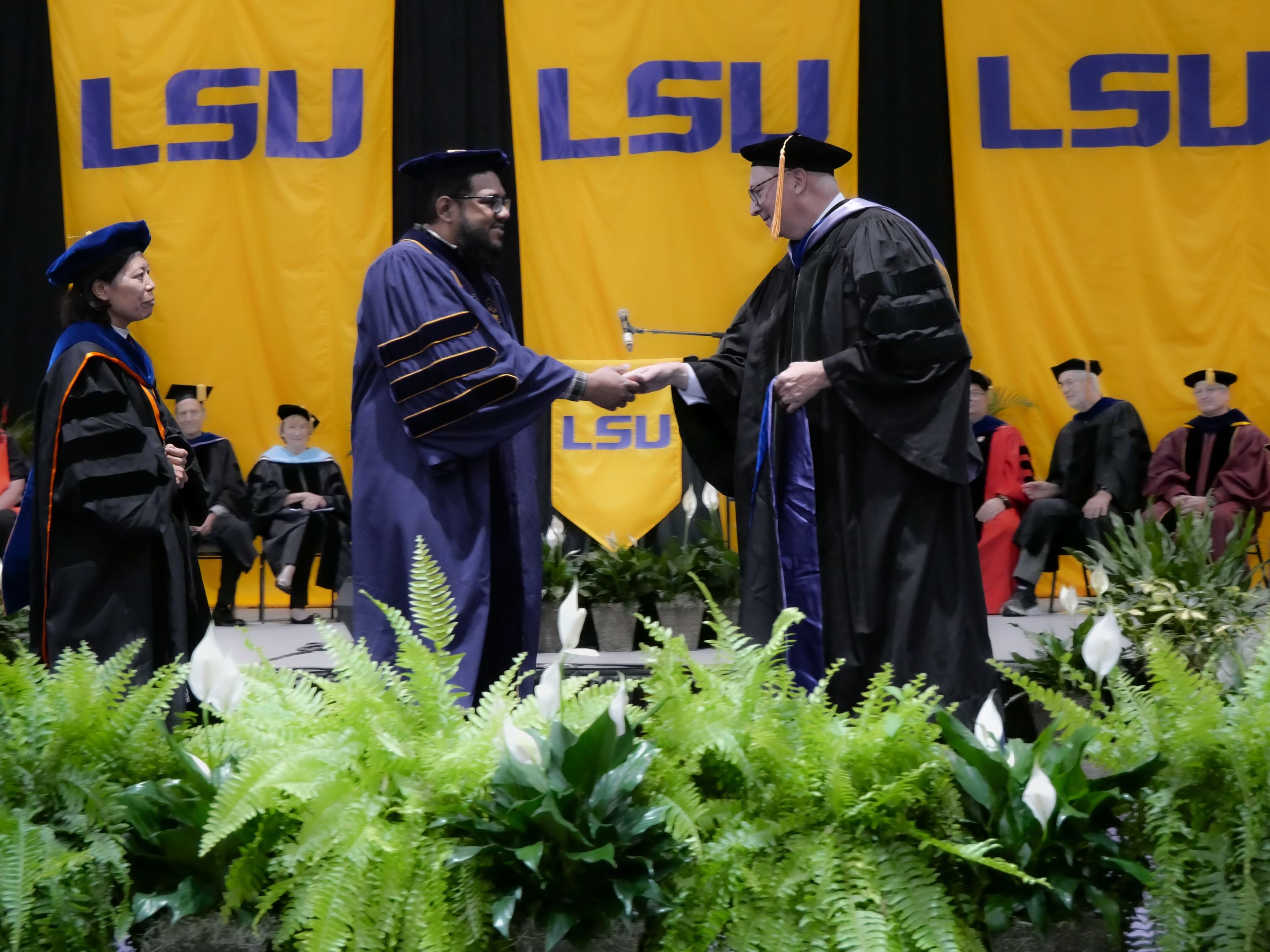 graduates receiving their diploma