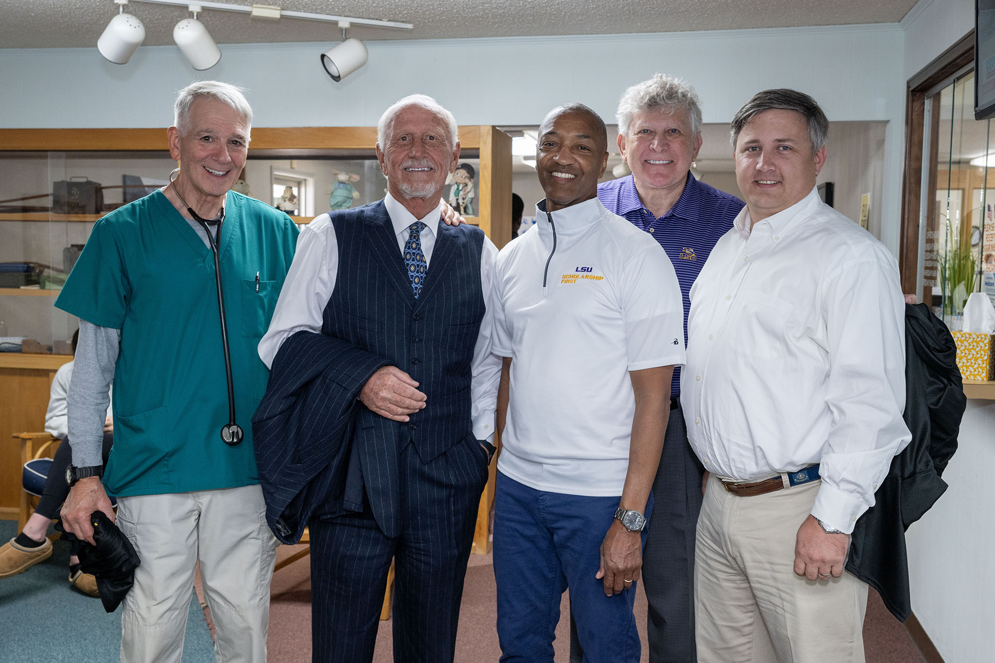 President Tate with group during health clinic tour