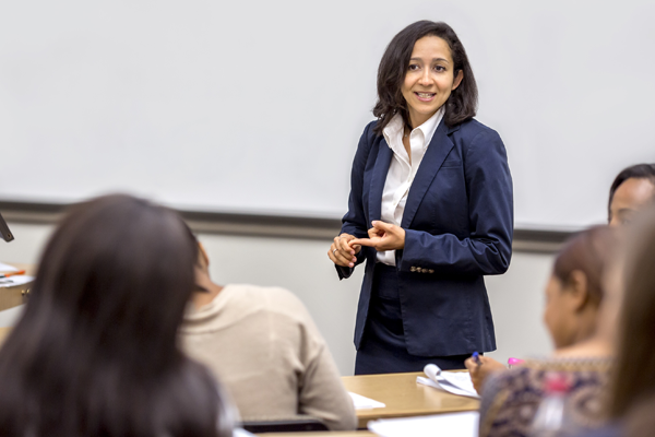 Professor teaches in front of classroom.