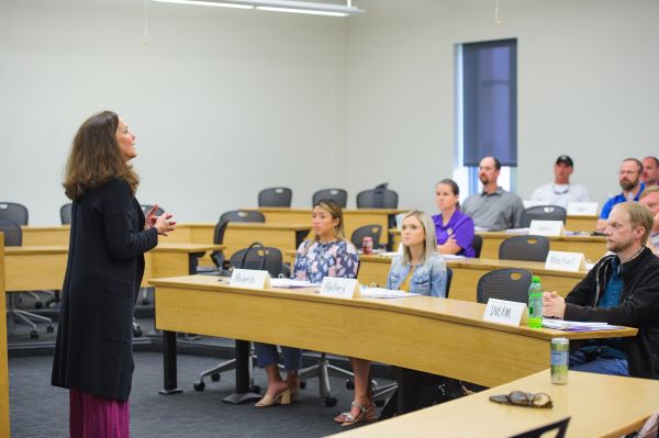 Class listens to instructor in classroom