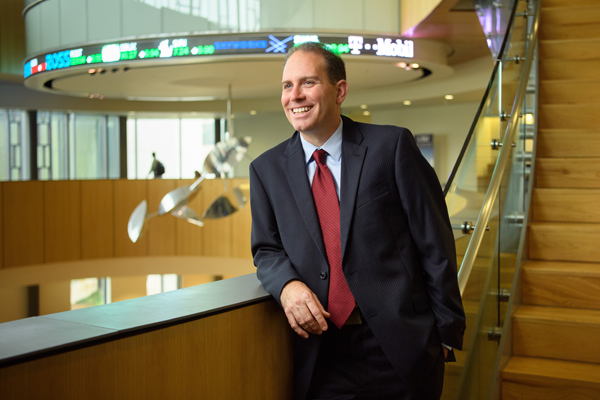 Andy Schwartz smiles on staircase in BEC Rotunda