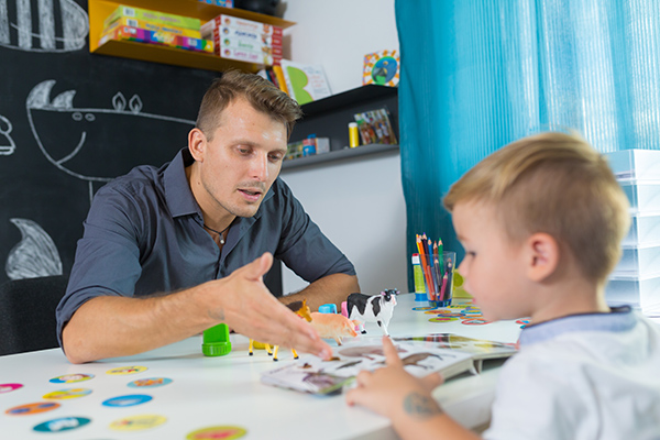 Child Lilfe Specialist working with a young boy