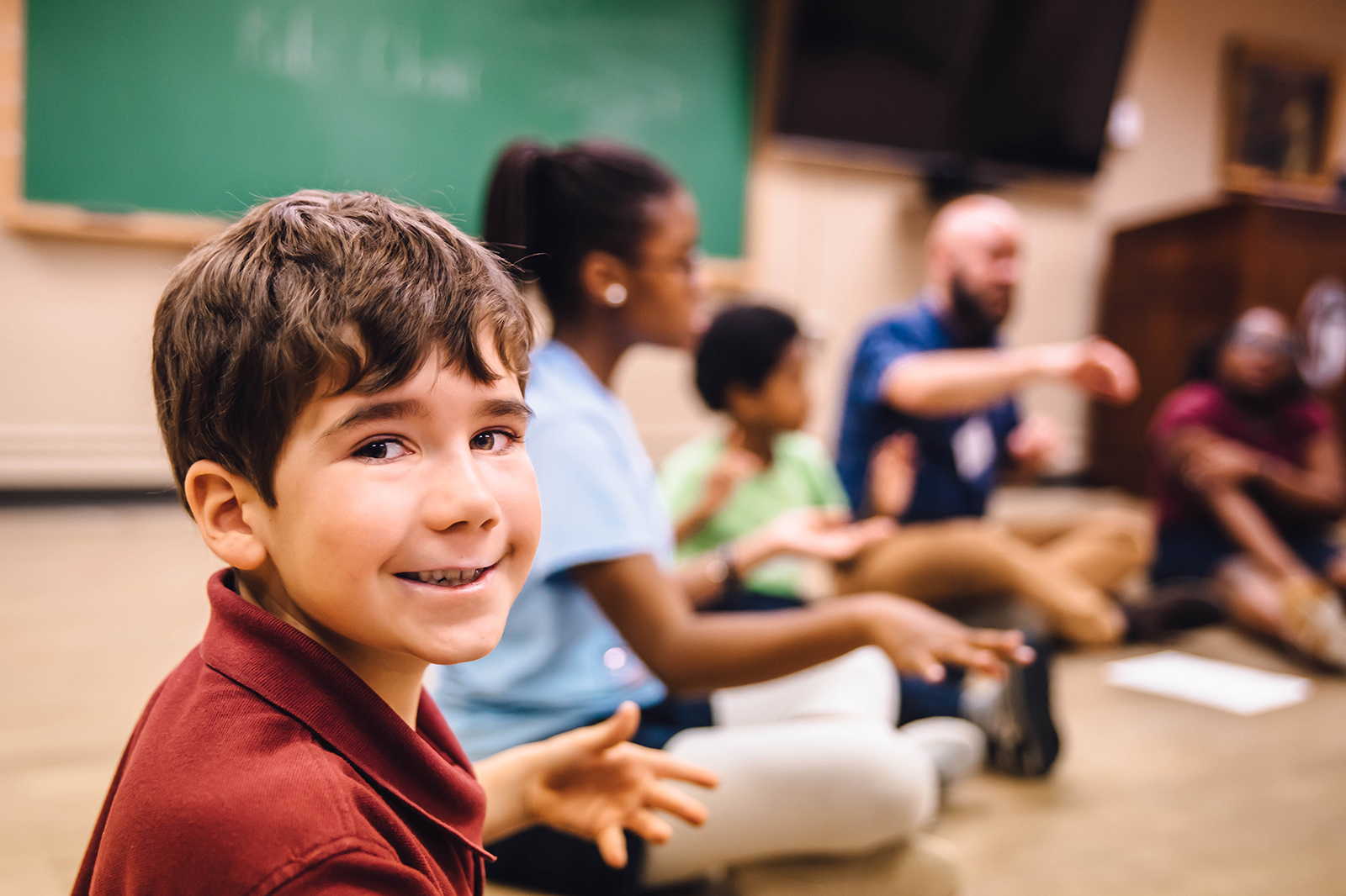 child looking at camera during kids orchestra lesson