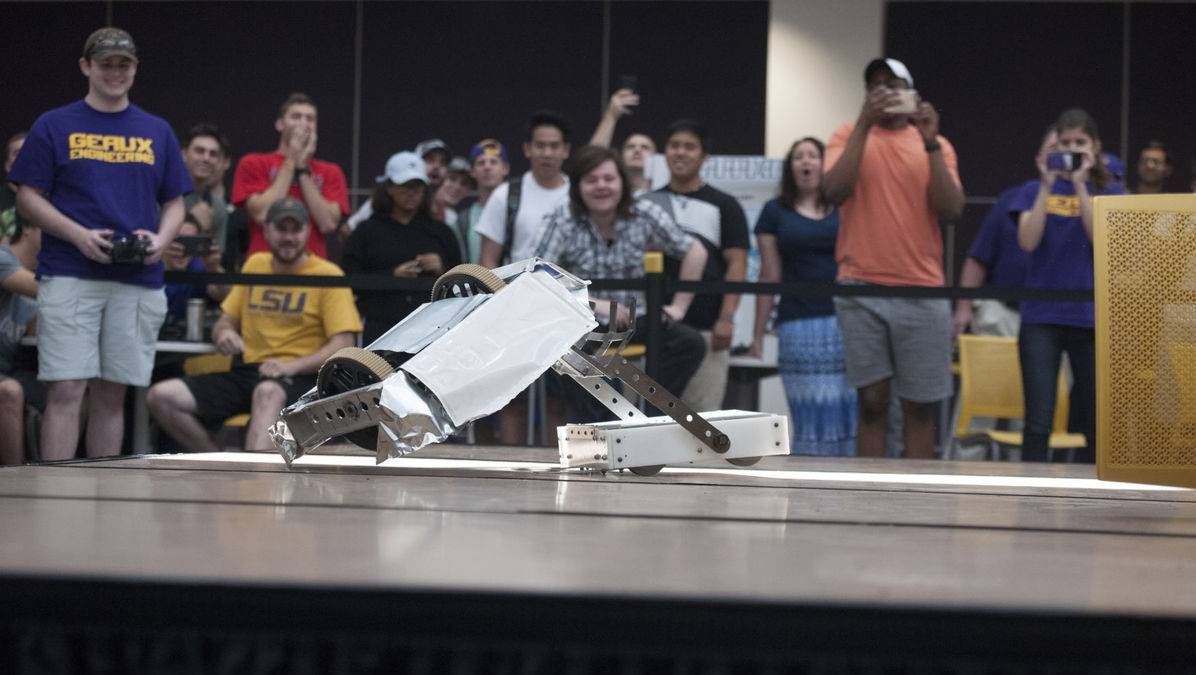 Students controlling robot on platform