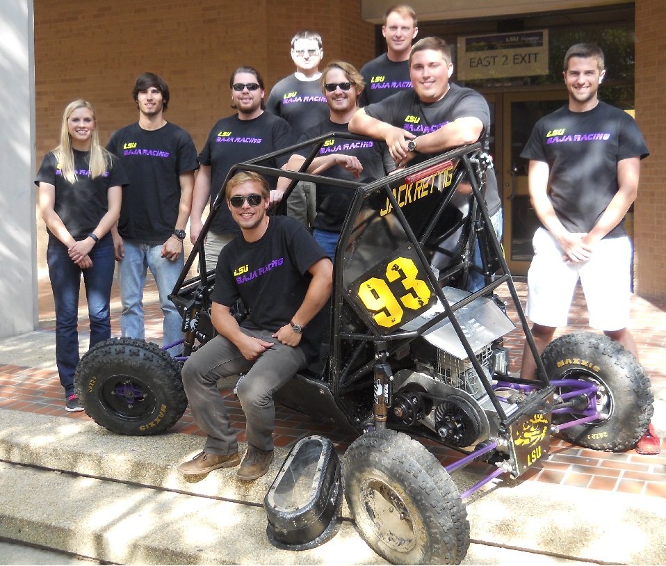 Group of students by small racecar