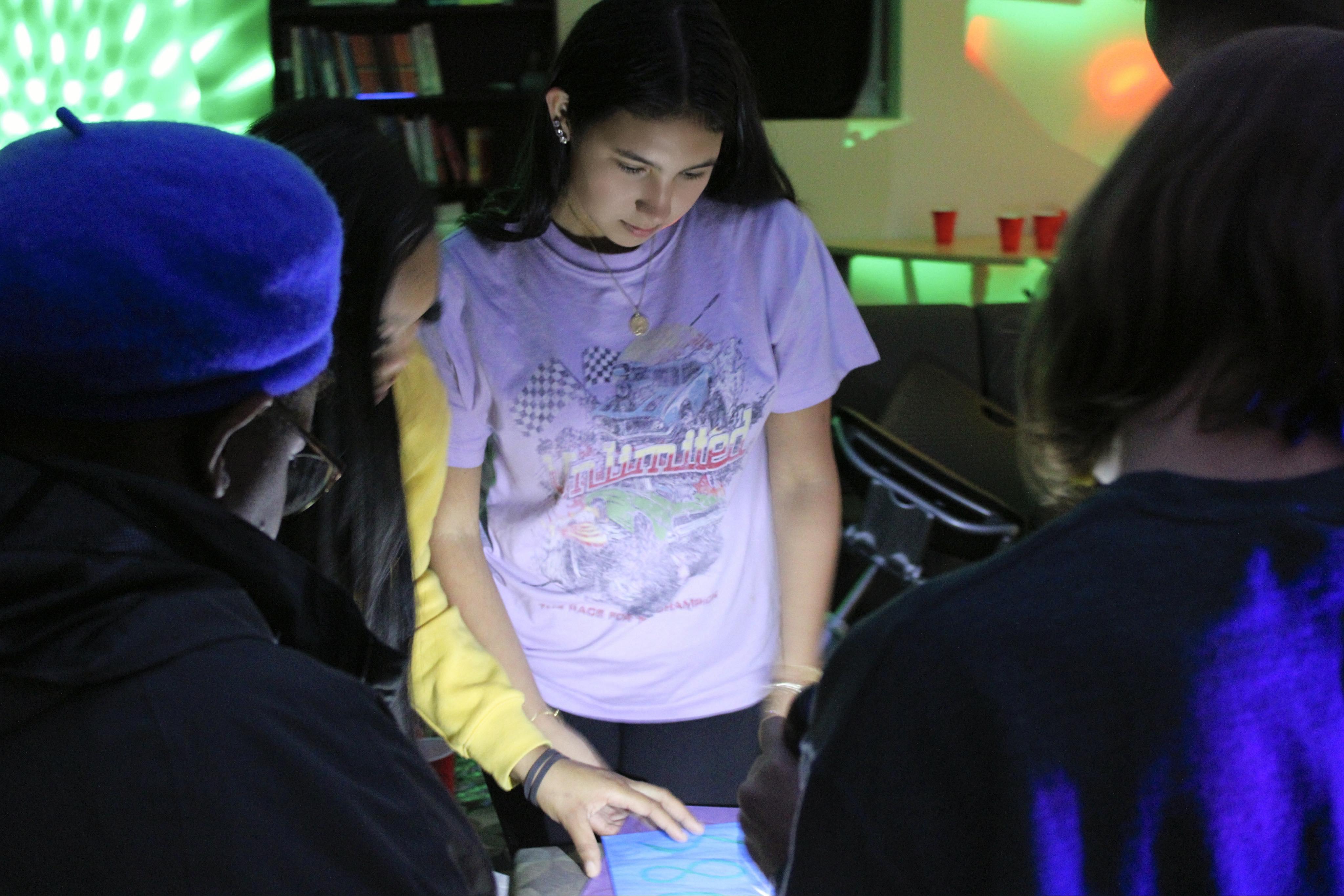 A student solving a puzzle at a Broussard Hall event.