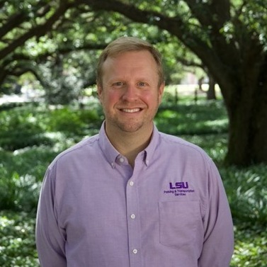 White man in PTS polo, smiling