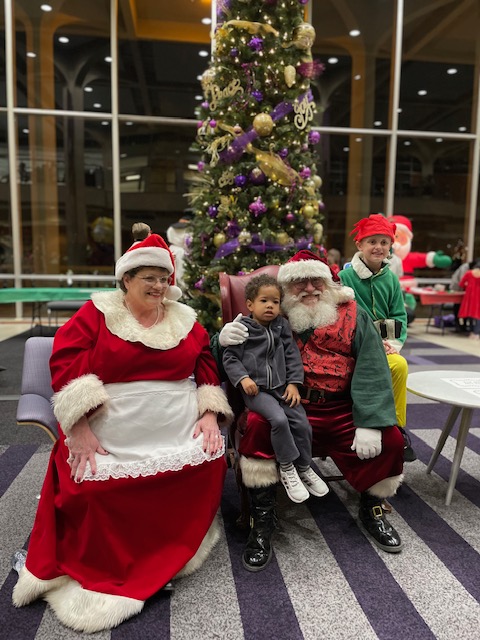 Santa Claus and Mrs. Claus with children