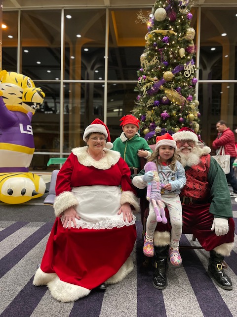 Santa Claus and Mrs. Claus with children