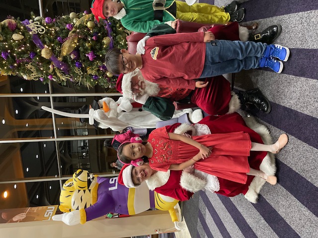 Santa Claus and Mrs. Claus with children